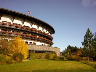 Building with a round roof under a blue sky.