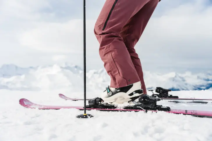 Legs and feet of a skier on a snowy slope