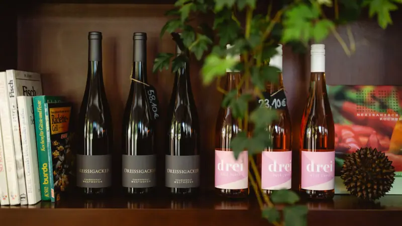 A group of wine bottles on a shelf