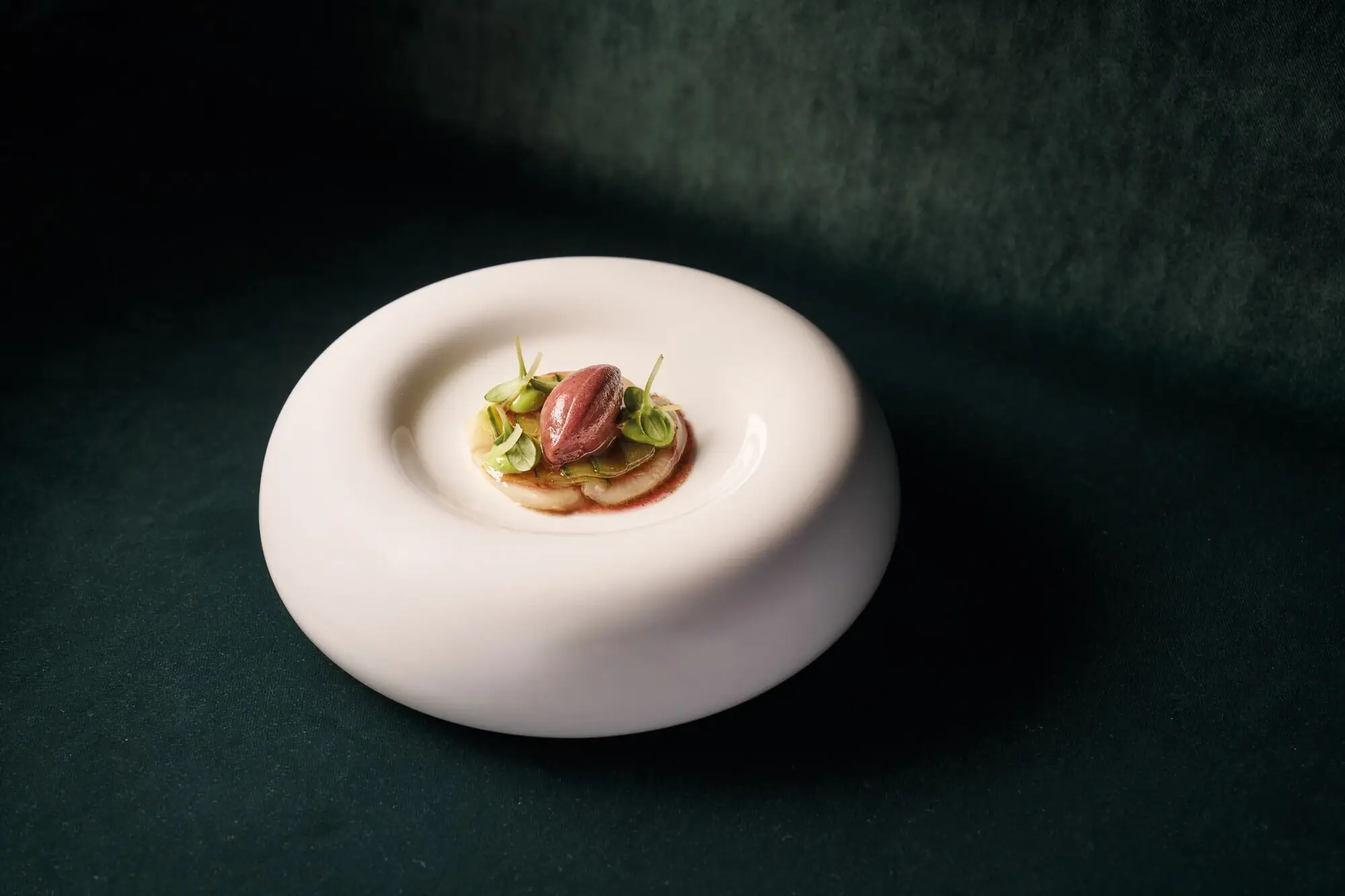White plate with artfully arranged food.