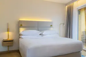 sleeping area A bed in a room with elegant bed linen and pillows.
