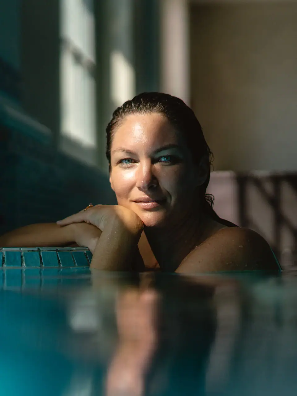A woman swims in an indoor pool.