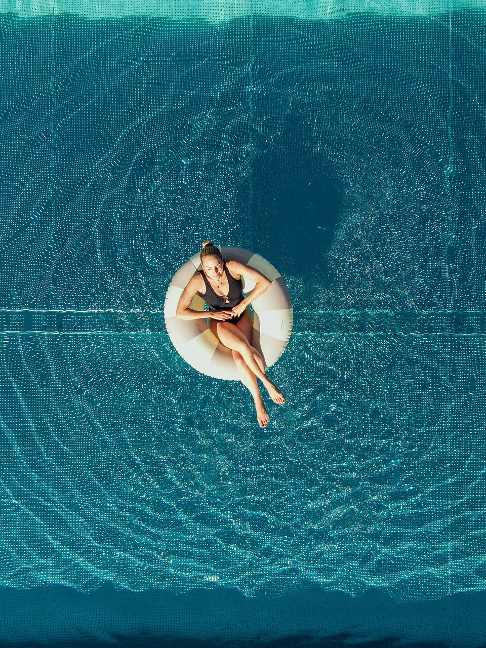 Pool floating tyre Woman sitting on a floating tyre in the pool