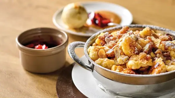 A bowl of Kaiserschmarrn on a plate.