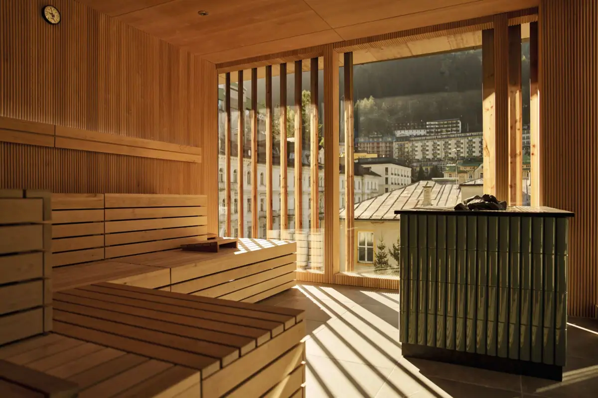 Bright Finnish sauna at the Straubinger Grand Hotel with panoramic views over Bad Gastein and the surrounding mountains.