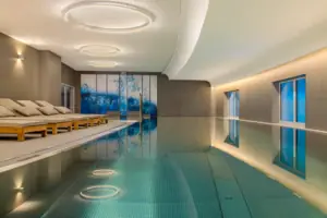 The indoor pool at the A-ROSA Hotel Tegernsee, with sun loungers around the edge.