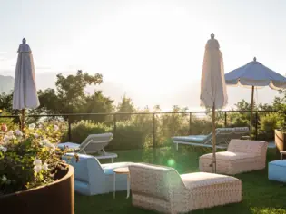 Various loungers on a green area at sunrise