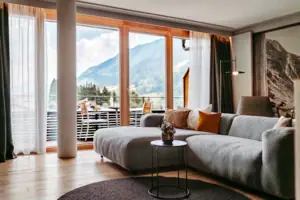 Living room with a large sofa and a table.