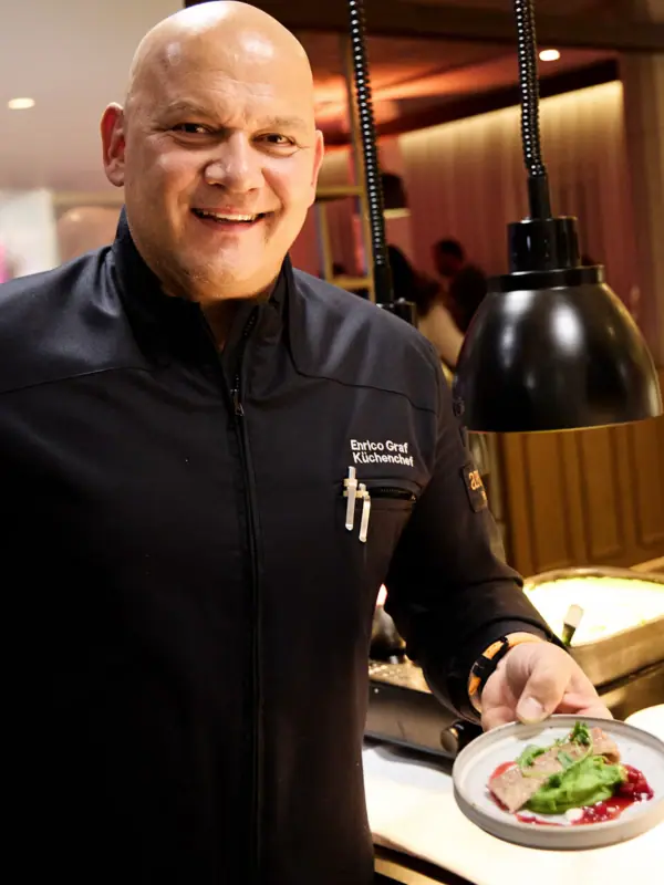 A man is holding a plate of food.