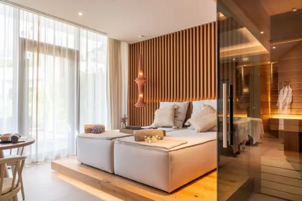A room with a bed and a glass door.