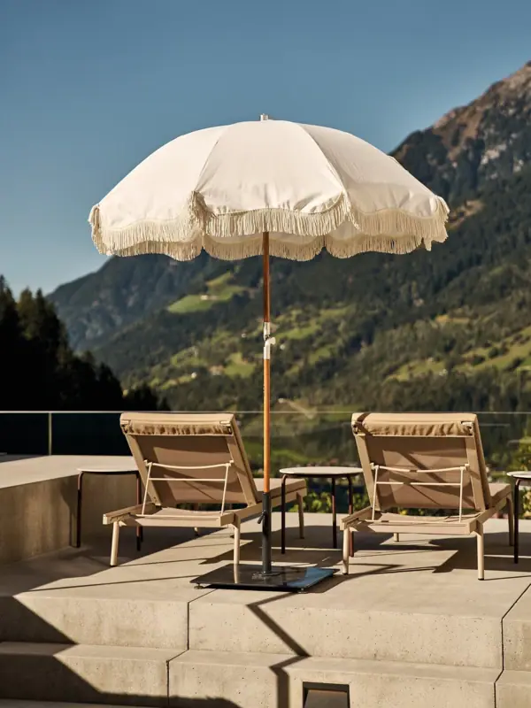 White parasols and chairs on a terrace.