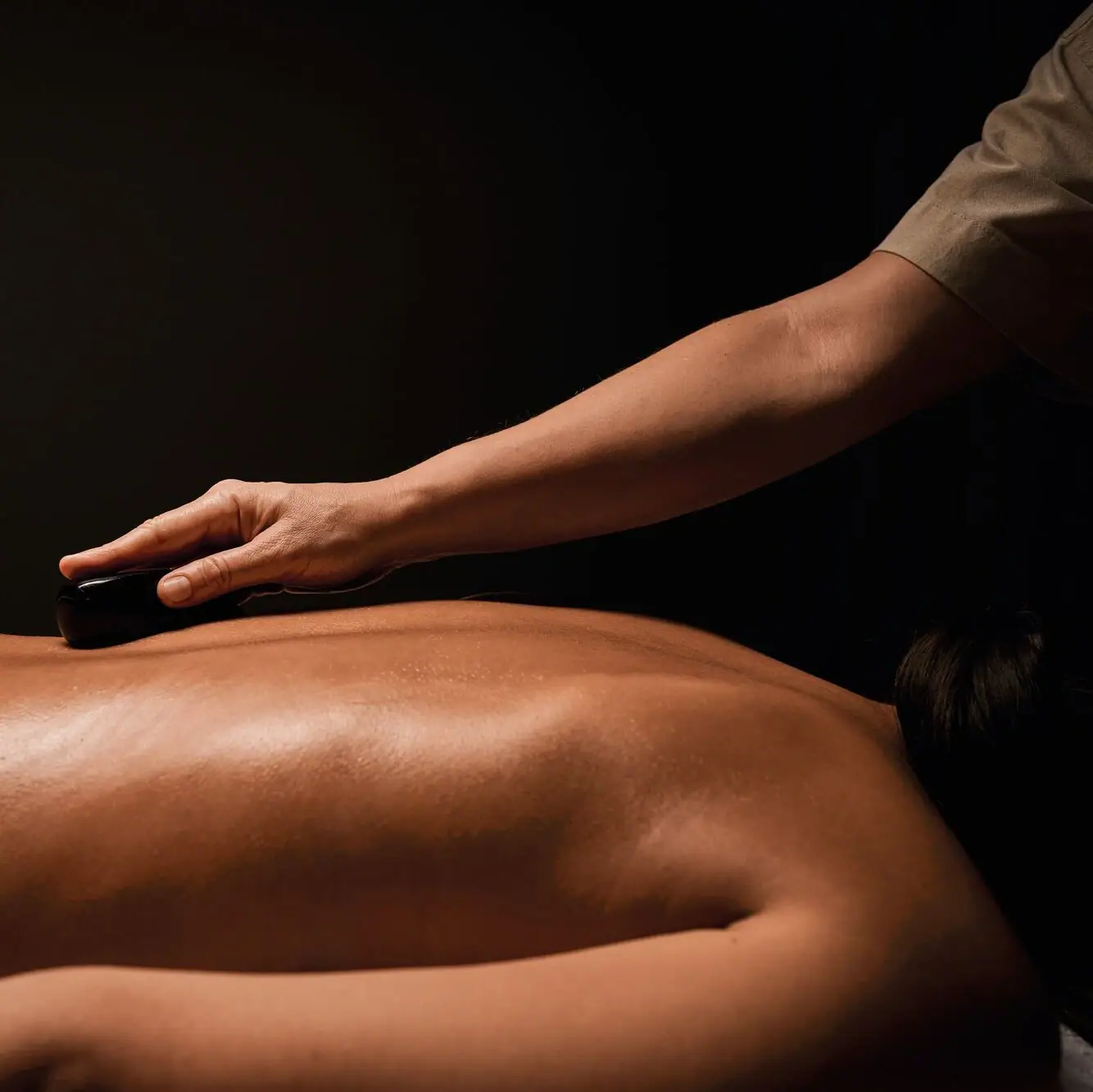 A person receiving a massage focuses on their back and shoulders.