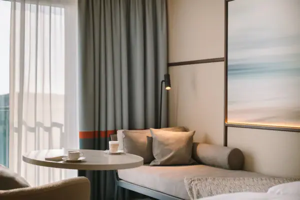 A sofa with a coffee table and a lamp in a room