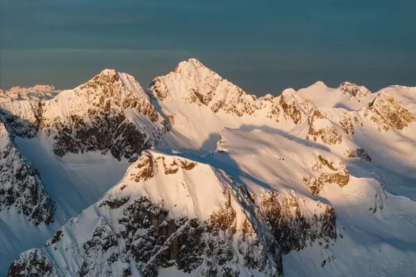 Snow-capped mountain peaks beneath a blue sky