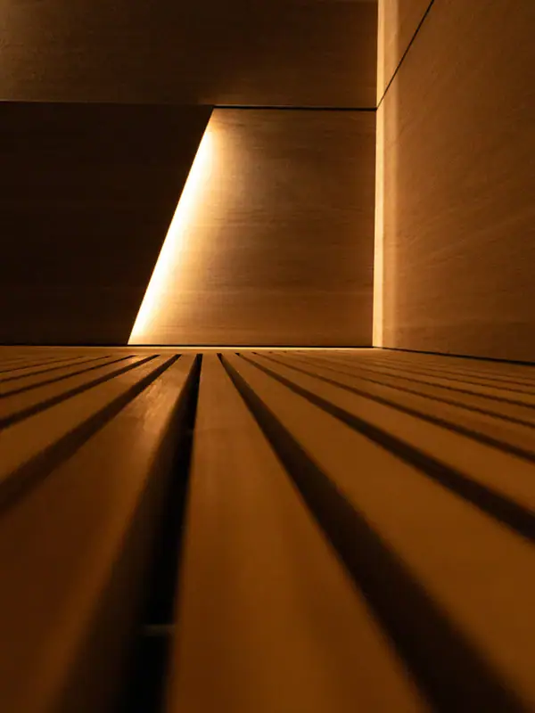 A wooden wall illuminated by light, showcasing symmetry and linear patterns.