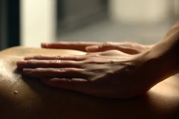 Anti-Stress Ritual A person's hand gently resting on another person's back.