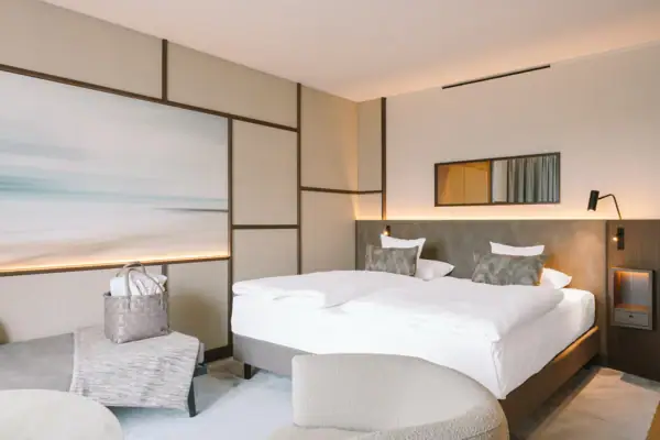 A room with a bed and a chair.