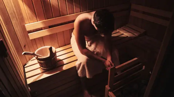 Man sitting in a sauna.