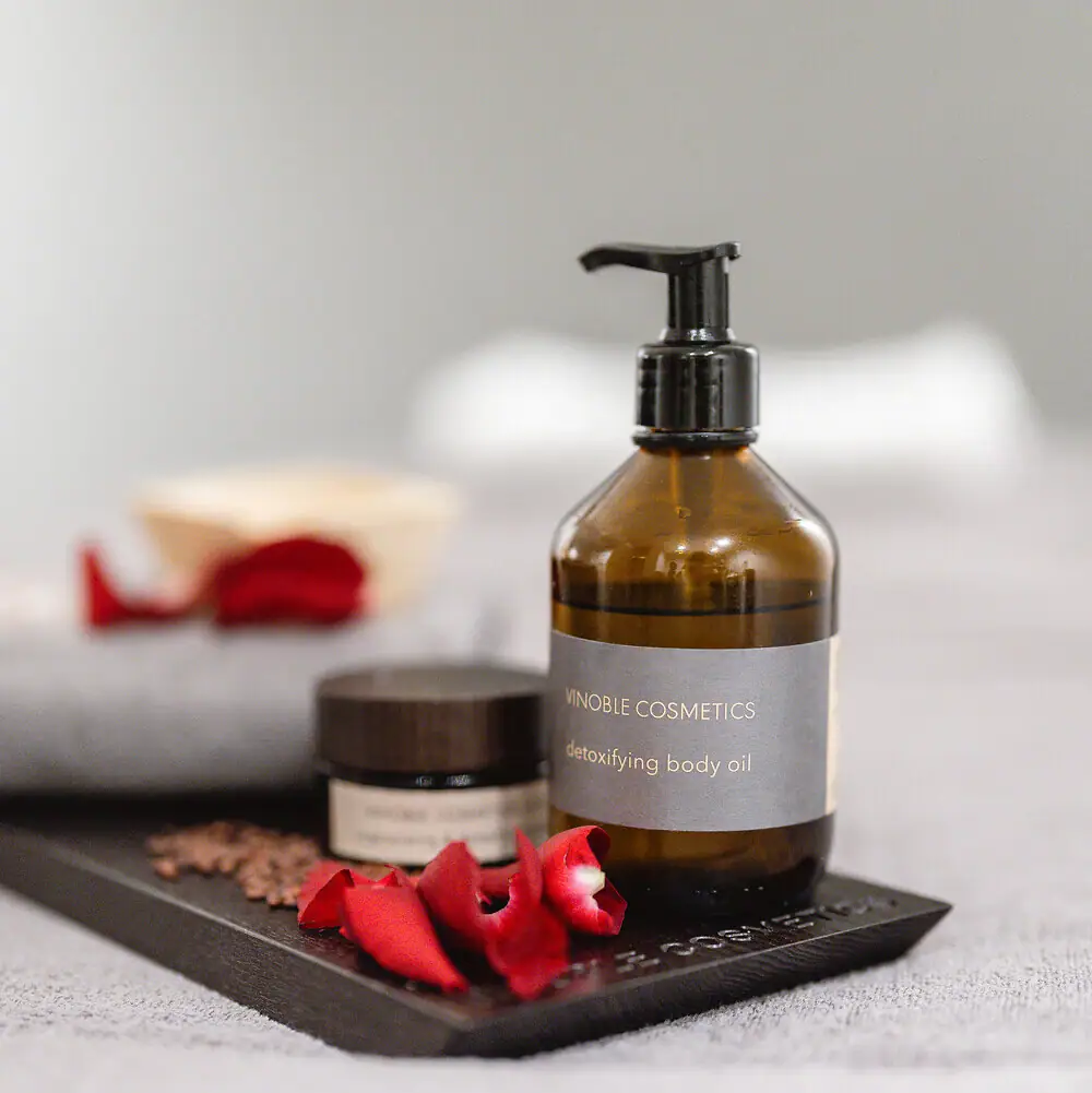Close-up of Vinoble Cosmetics skincare products with rose petals at the Straubinger Grand Hotel Spa.