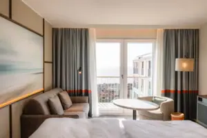 Hotel room with a bed and a sofa.