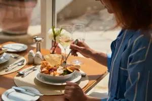 A woman is eating a bowl of food.
