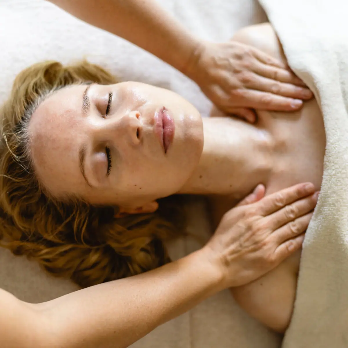 Woman receiving a massage indoors, lying comfortably.