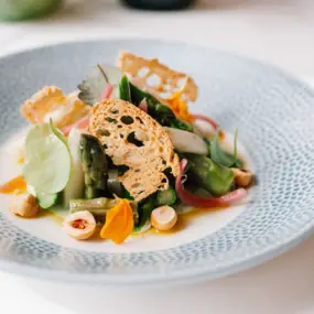 A plate with artfully arranged food on a table.