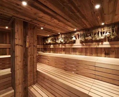 A wooden sauna with ambient lighting and hardwood details.