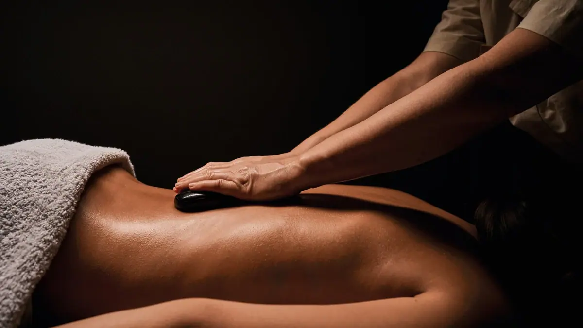 One person receives a hot stone massage.