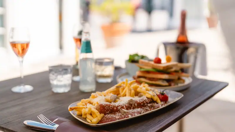 Currywurst A plate of food on a table.
