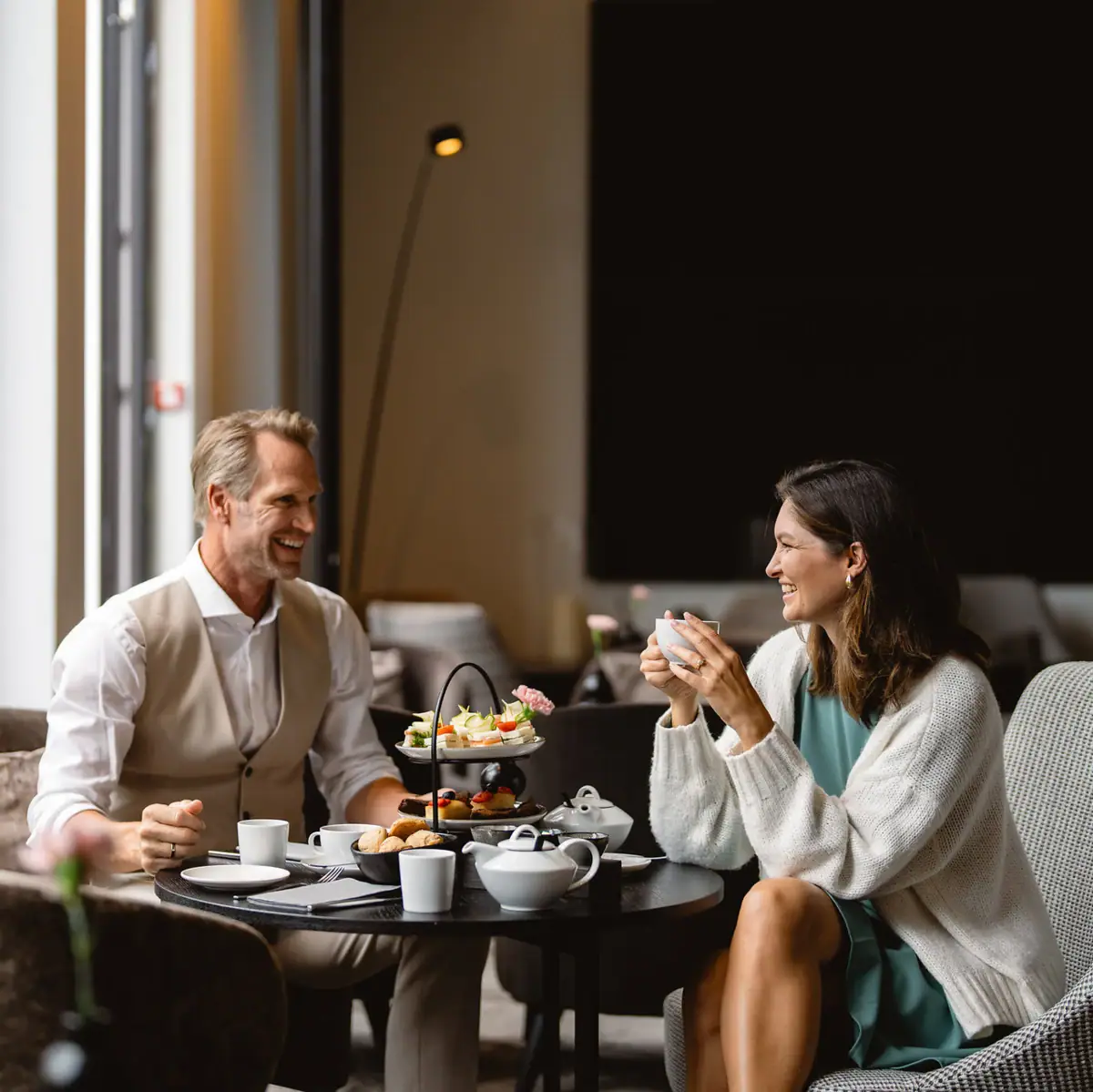 A man and a woman are sitting at a table in a restaurant.