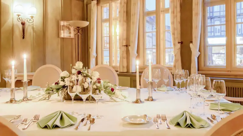 Ein festlich gedeckter Tisch für eine Dinnerparty im Innenbereich.