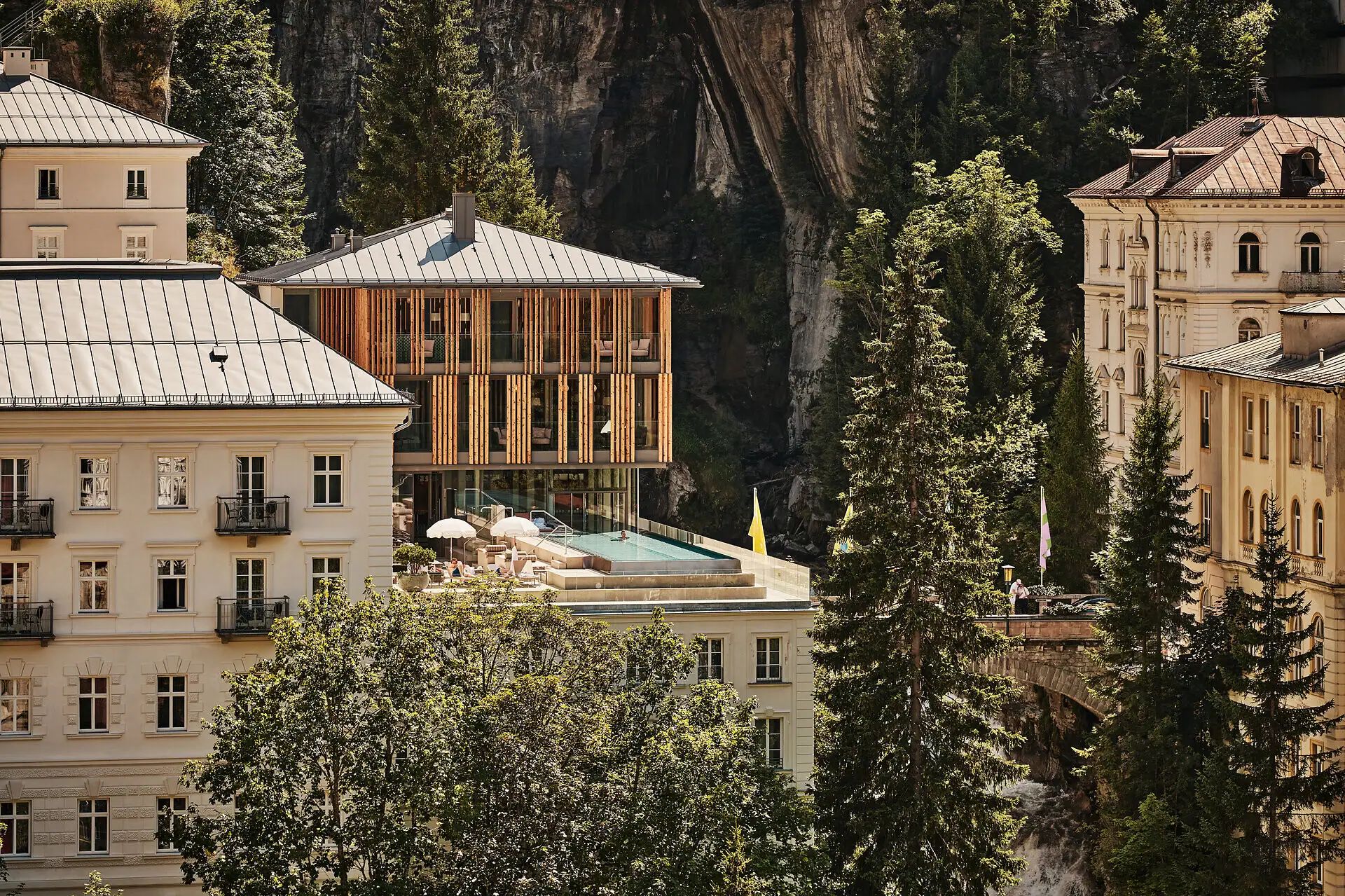 Straubinger Grand Hotel in Bad Gastein next to the waterfall with mountain backdrop.