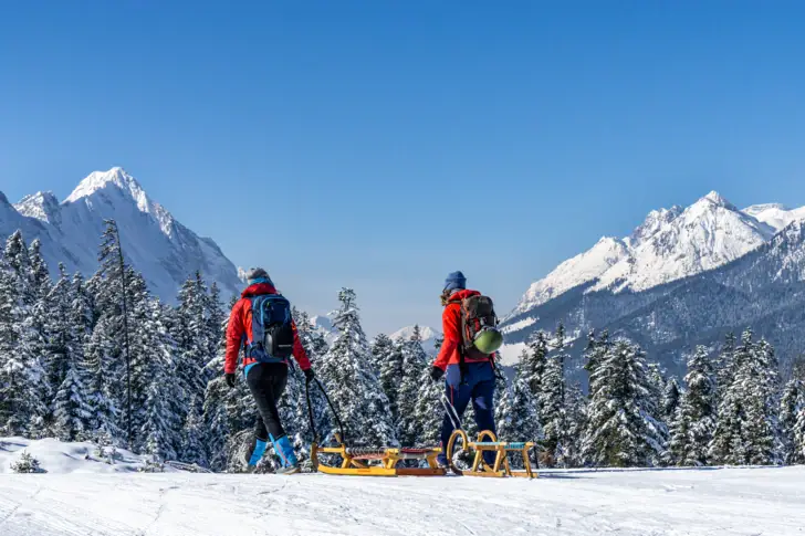 A group of people walking on a snowy mountain.