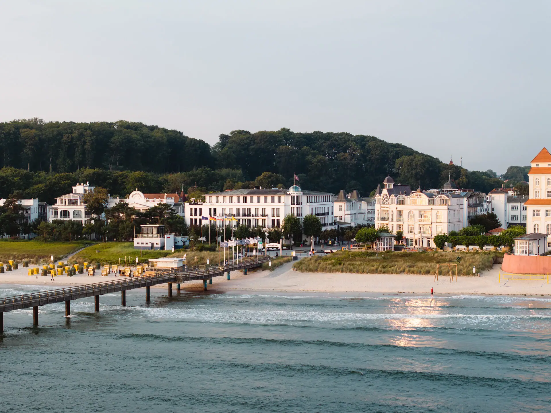 A body of water with buildings and trees in the background