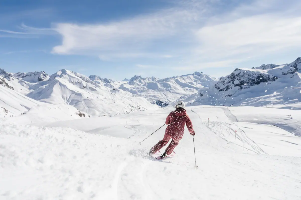 A person is skiing down a snow-covered mountain.